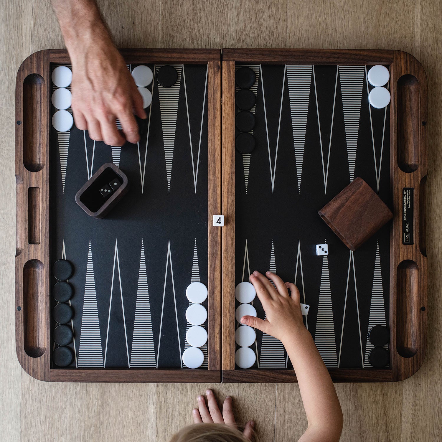 kid and dad playing backgammon