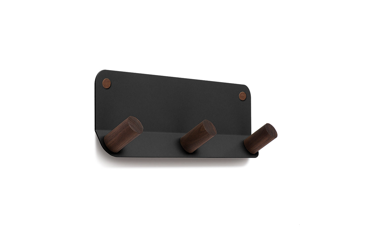 A black Plane 3 Wall Hook coat rack with two wooden hooks by Fire Road.