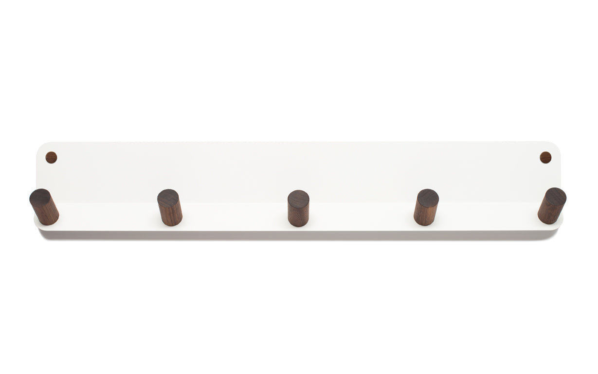 A Fire Road wall-mounted storage with four wooden Plane 5 Wall Hook coat hooks.