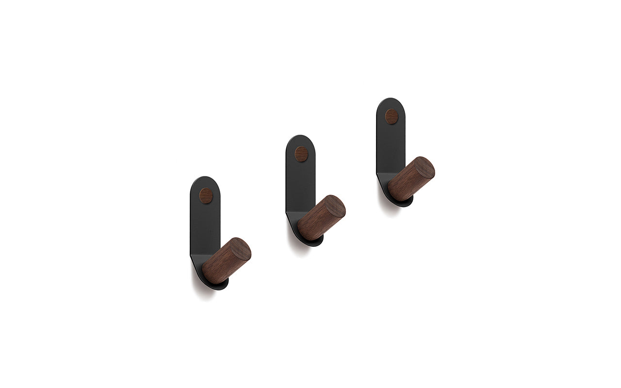 Three black Plane Single Hooks - Set of 3 by Fire Road, made of powder coated steel feature wooden pegs, all mounted vertically against a white background.