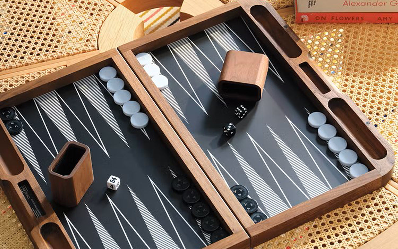 A Fire Road Skyline Backgammon Set on a wooden table.