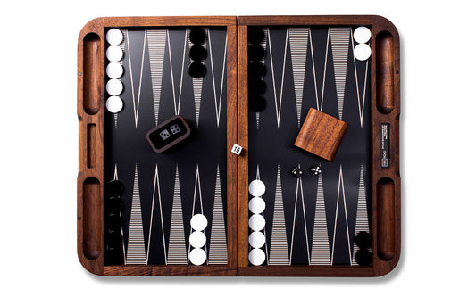 backgammon board with playing pieces and dice cup