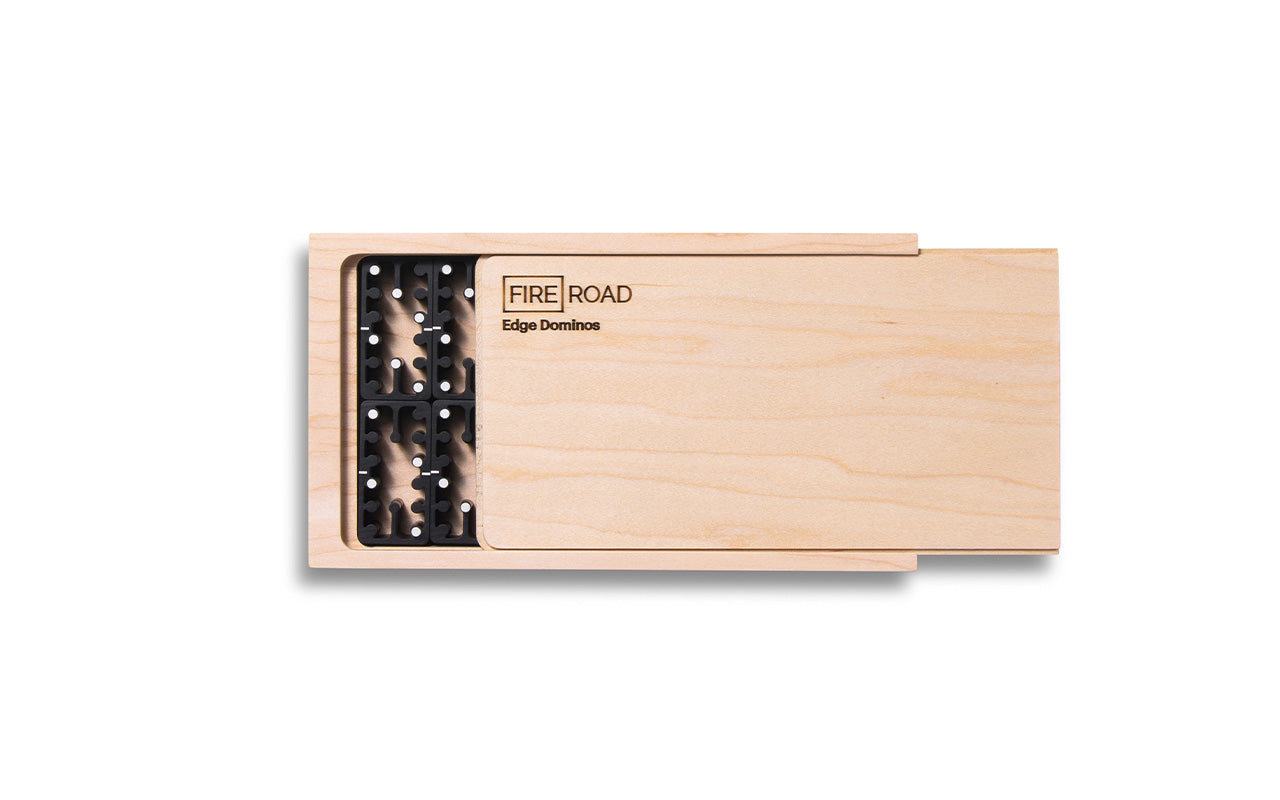 top view of maple box with black aluminum domino set