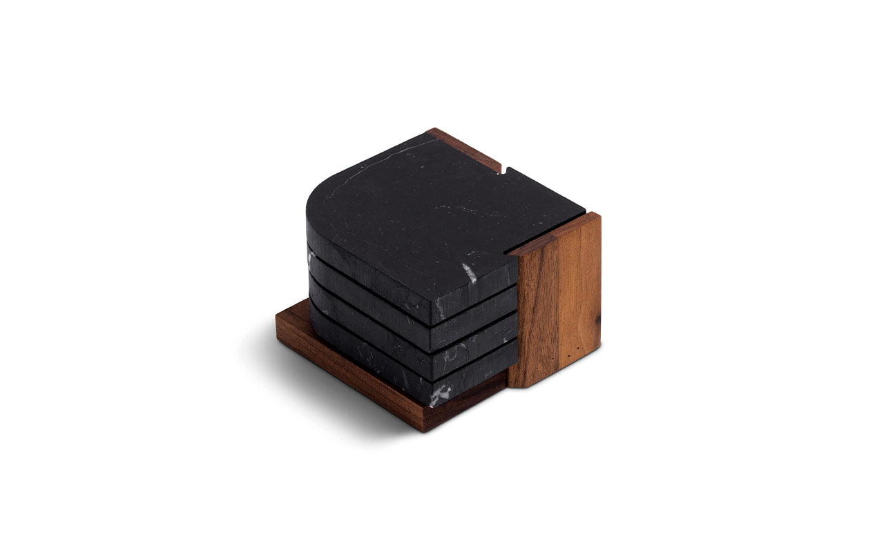 black marble coasters on walnut stand