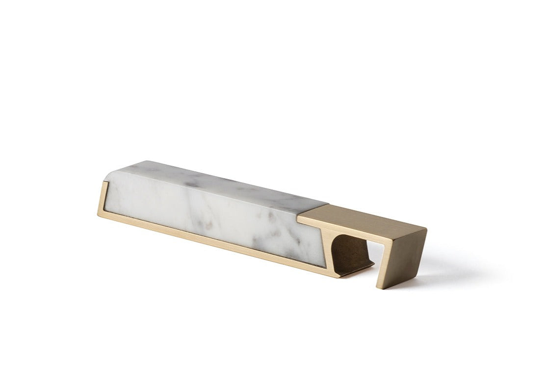 A Fire Road Carrara marble holder for the Fire Road Profile Bottle Opener.