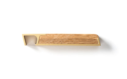 A wooden handle with a gold finish, perfect for the Fire Road Profile Bottle Opener.
