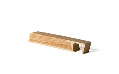 A wooden box with a brass handle on a white surface. Keywords: wooden handle.
Product Name: Profile Bottle Opener
Brand Name: Fire Road

Revised sentence: A Profile Bottle Opener with a brass handle on a white surface.