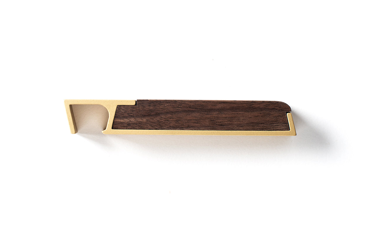 A Fire Road Profile Bottle Opener transcends utility on a white surface.