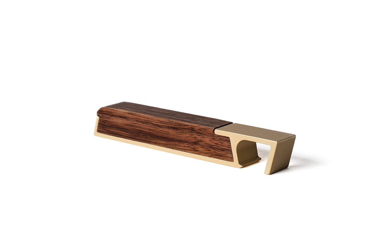 A wooden box with a brass handle and a Fire Road Profile Bottle Opener.