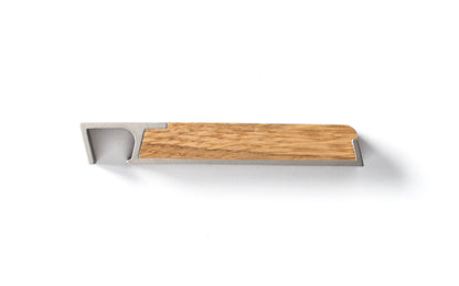 A wooden handle on a Fire Road Carrara marble surface