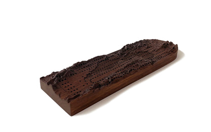 A Fire Road Terrain Cribbage Board with a mountain on it.