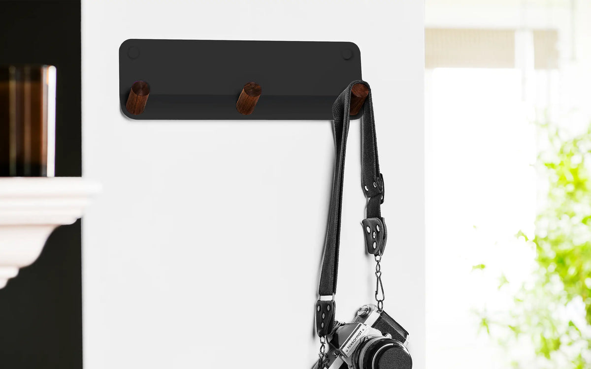 wall hook and wall shelf with green vase and army green coat