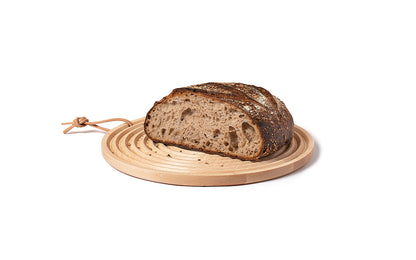 round bread board with grooves for catching crumbs